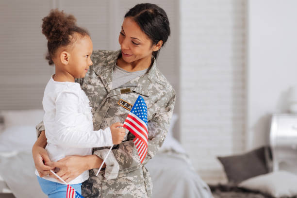 istock Adorable child and her mom holding little flags 654668298