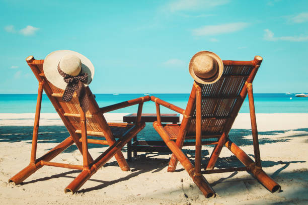 istock hats on chairs of tropical sand beach 654679922