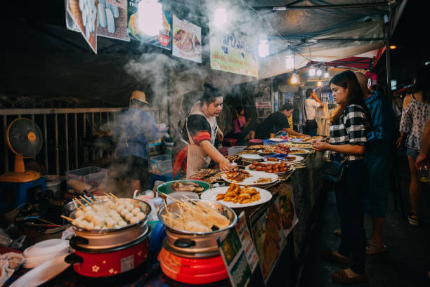 Saturday night market in Chiang Mai, Thailand Chiang Mai, Thailand - August 27, 2016: Thai woman sales at the Saturday Night Market on August 27, 2016 in Chiang Mai, Thailand. night market stock pictures, royalty-free photos & images