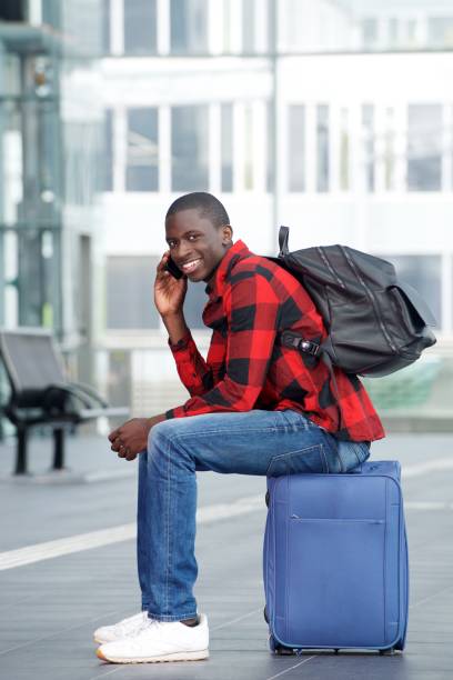 istock Young african traveler waiting at rail station 654703610