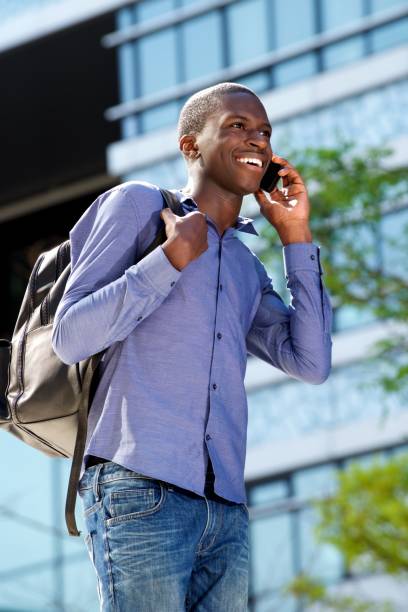 istock Happy african man talking on mobile phone and smiling 654703684