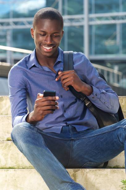 istock Young african man with mobile phone 654703758