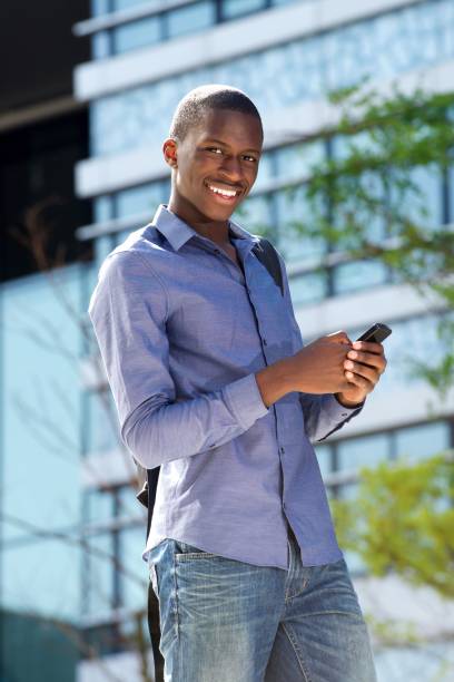 istock Young african guy with mobile phone 654703814