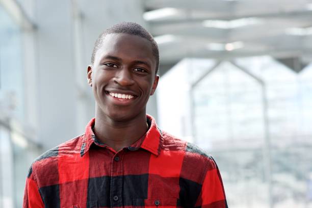 istock Happy young african man standing outside 654703824