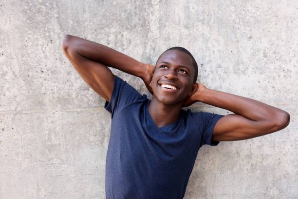 istock Young african man with hands behind head and looking up 654703872