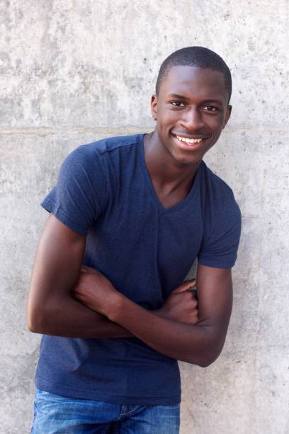 istock African american guy smiling with arms crossed 654703894