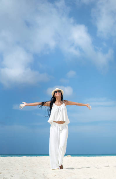 istock Beautiful woman relaxing at the beach 654709756