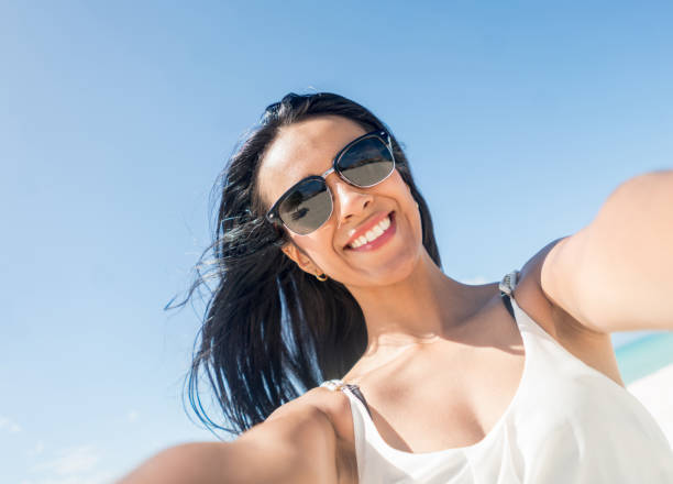 istock Woman taking a selfie at the beach 654709794