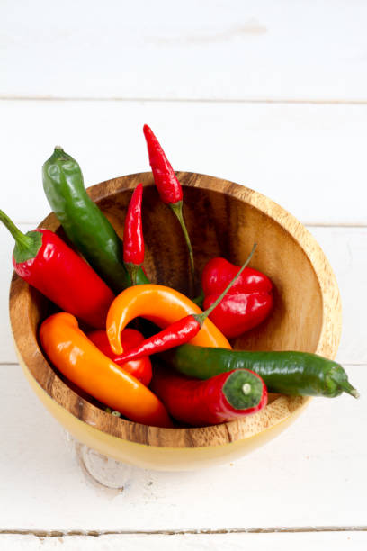 istock Chilli peppers mix in yellow bowl. 654710238