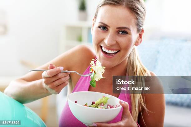 Foto de Jovem Mulher Comendo Salada Saudável Após Treino e mais fotos de stock de Alimentação Saudável - Alimentação Saudável, Mulheres, De Dieta