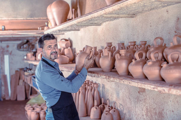 istock Smiling male sculptor in pottery atelier 654715968