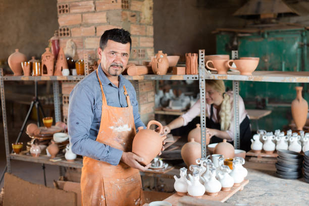 istock Positive male artisan having ceramics in hands 654715990