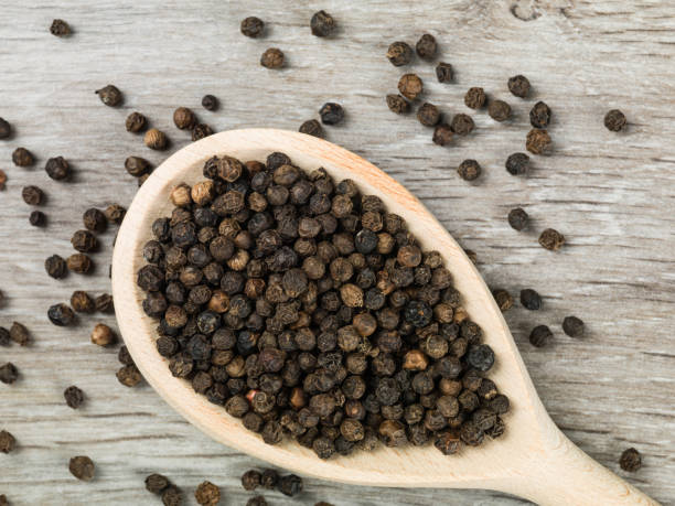 istock Black Peppercorns Food Seasoning on a Spoon 654721040