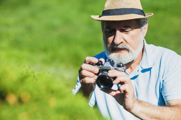 istock Senior man taking pictures with photo camera 654721166