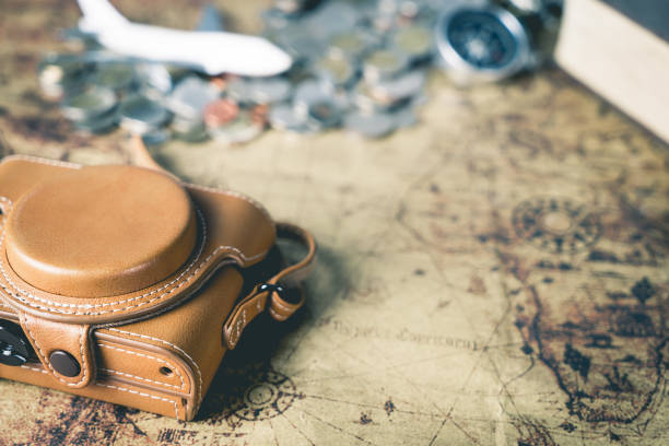 istock Leather camera case and traveler equipment on vintage map 654722182
