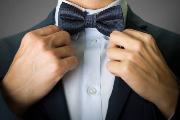 istock Close up on a man in navy blue tuxedo suit and bow tie 654722888