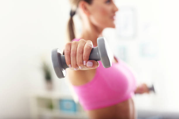 istock Sporty woman working out at home 654727152