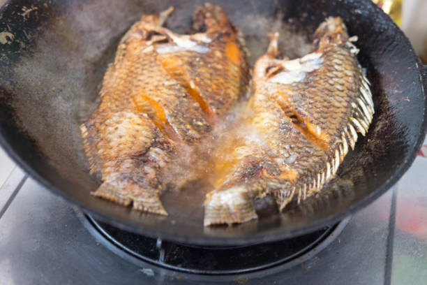 istock Fried fish in a frying pan in the kitchen 654729282
