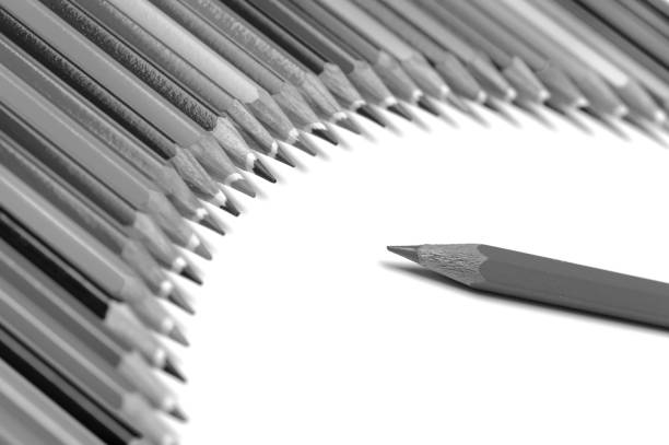 Group of silver pencils with pink vibrant background. Standout and be different from others concept. Be different, break social norm concept represented by pencils.