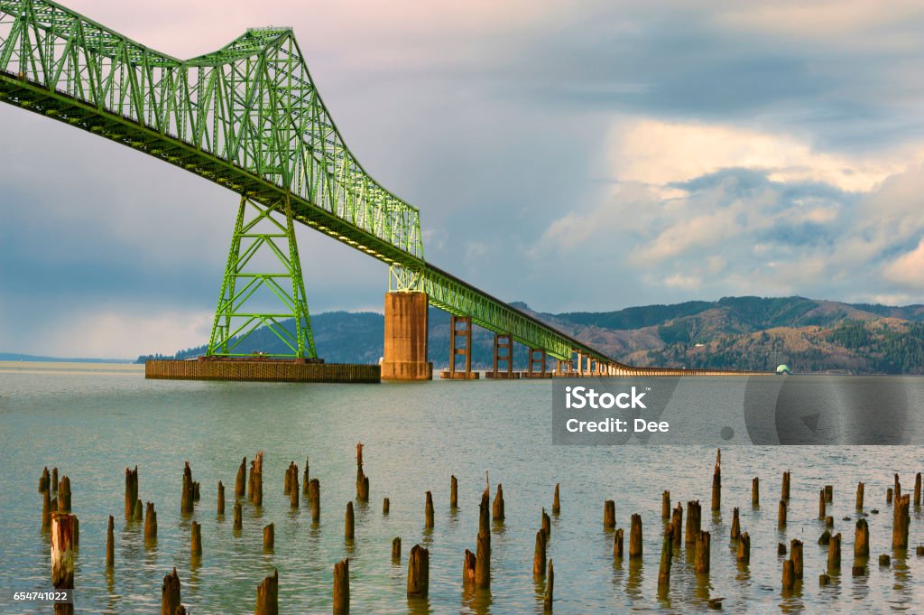 View of Megler Bridge in Astoria, Oregon Rain clouds at Megler Bridge in Astoria, Oregon.  The bridge spans the four mile width of the Columbia River, connecting Oregon and Washington States on the coastal highway 101.  The bridge first opened to traffic on July 29, 1966. Columbia River Stock Photo