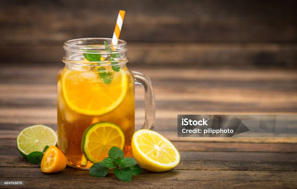 Ice tea with lemon, lime and mint Ice Tea Stock Photo