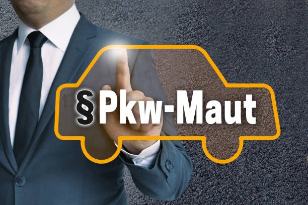 istock PKW-Maut (in german Car toll) auto touchscreen is operated by businessman concept 654744308