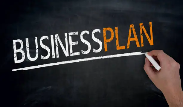 Businessplan is written by hand on blackboard.