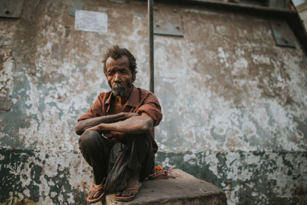 Homeless old man seated in New Delhi