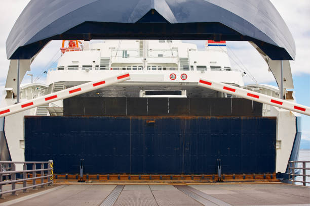 istock Norwegian car ferry landing at port. Open barrier 654751166