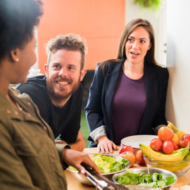 istock Friends preparing salad at home in the kitchen. 654756616