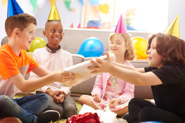 Passing The Parcel Stock Photo - Download Image Now - Party Game, 6-7 Years, 8-9 Years - iStock