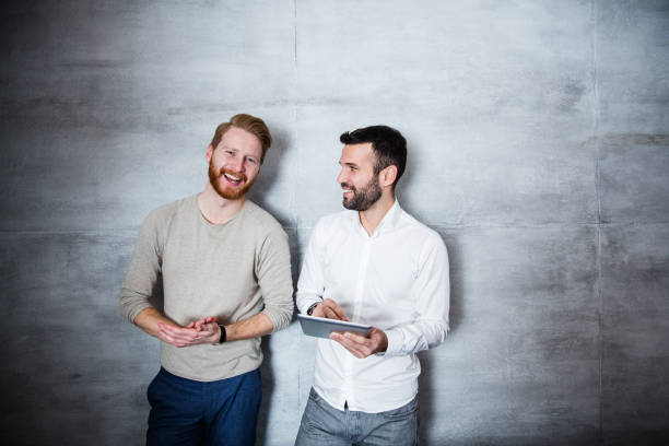 istock Friends discussing and looking at camera 654760024