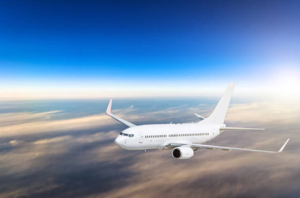 istock Airplane in the sky above the clouds flight journey sunset height 654761702