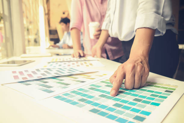 istock Graphic design and color swatches and pens on a desk. Architectural drawing with work tools and accessories. 654766896