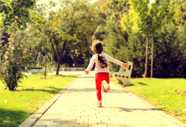 Freedom Girl with arms outstretched running on park, Running with sunset, i 5 stock pictures, royalty-free photos & images
