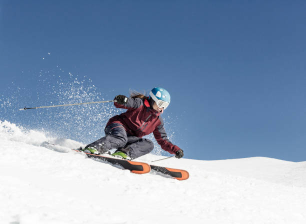 Woman carving skiing stock photo