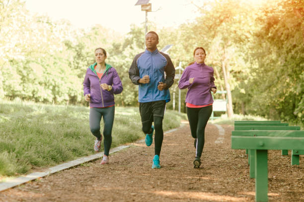 istock Friends jogging in park 654787816