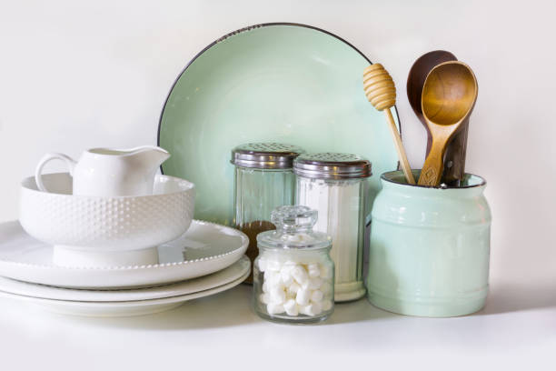 istock Crockery, tableware, utensils and other different white and turquoise stuff on white table-top. Kitchen still life as background for design.  Image with copy space. 654791058