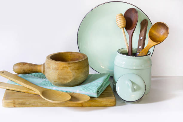 istock Crockery, vintage tableware, utensils and other different white and turquoise stuff on white table-top. Kitchen still life as background for design. Image with copy space. 654795182