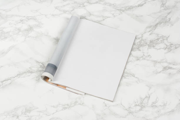 istock Mock-up magazines or catalog on white marble table background. 654799360