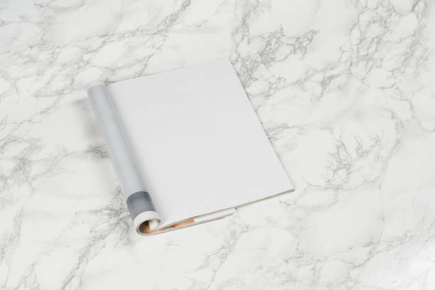 istock Mock-up magazines or catalog on white marble table background. 654799388