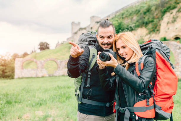 istock Young Couple Backpackers Photographing Historical Monument 654804926