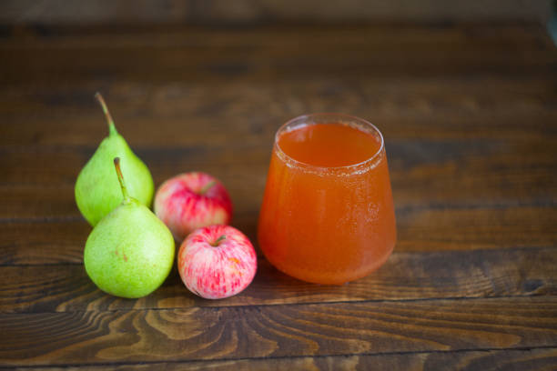 istock Delicious fresh squeezed Apple-pear juice in  transparent glass 654805026
