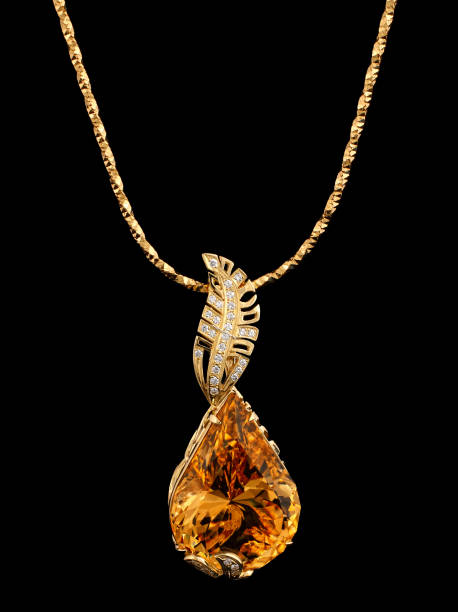 istock Golden pendant with gem and diamonds on black 654813028