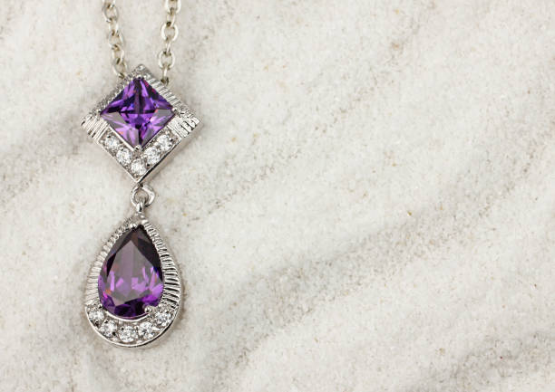 istock jewelry pendant with diamonds on white sand background, copy space 654815756