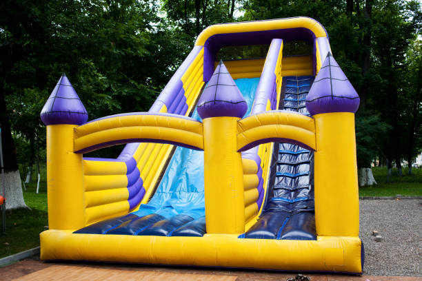 Bouncy castle slide Inflatable big bouncy castle slide in a park air jump stock pictures, royalty-free photos & images