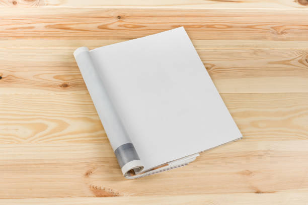 Mock-up magazines or catalog on natural wooden table background.