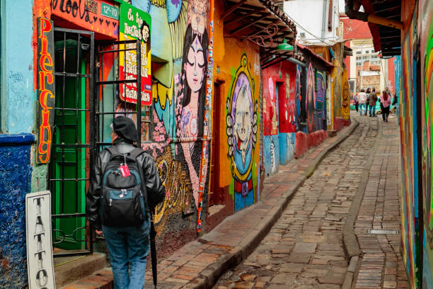 Bogota, Colombia - Tourists and Local Colombians on the Calle del Embudo, in the Historic La Candelaria District of the Andean Capital City stock photo
