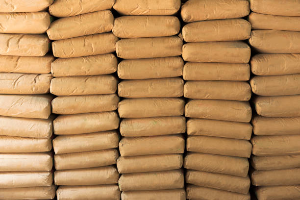 Cement powder bags stacked background Cement powder bags stacked background cement bag stock pictures, royalty-free photos & images