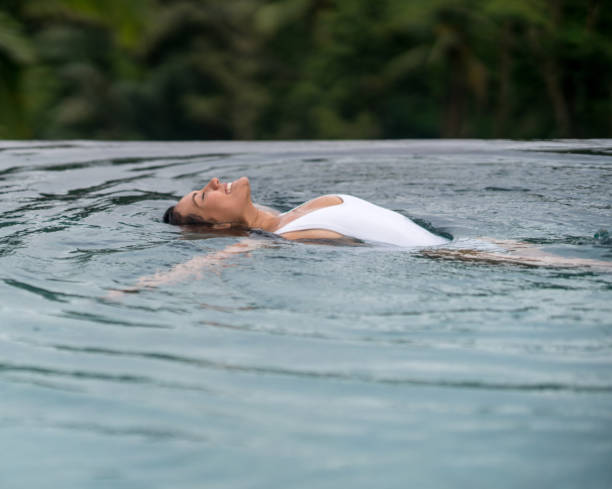 istock Woman relaxing in the pool 654862892